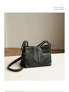 Black leather shoulder crossbody bag detailed view with double straps and minimalist design