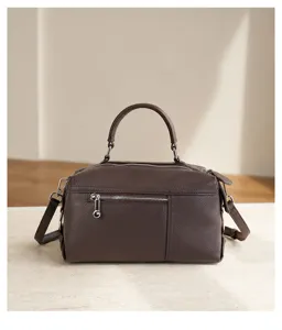 Minimalist top layer cowhide handbag and shoulder bag for daily commuting and large capacity use.
