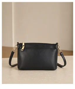 Detailed view of the black leather crossbody bag showcasing premium texture and hardware.