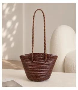 Handmade woven leather bucket bag detail, showcasing intricate craftsmanship and texture.