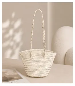 Detailed shot of a French vintage woven bucket bag, elegant handmade leather handbag design.