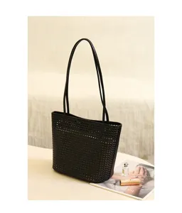 Detailed view of the black leather woven tote bag, showcasing fine craftsmanship and texture.