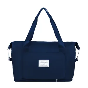 Large capacity foldable travel duffel bag in dark blue with dry wet separation layer.