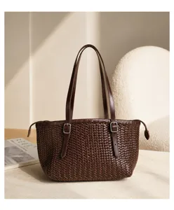 Detailed view of vintage brown woven leather tote bag, premium cowhide handbag with double straps.