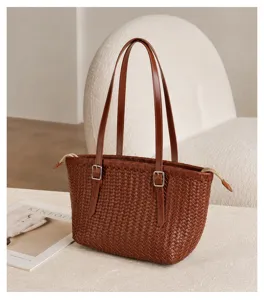 Brown woven leather tote bag detail, vintage shoulder bag craftsmanship close up view.