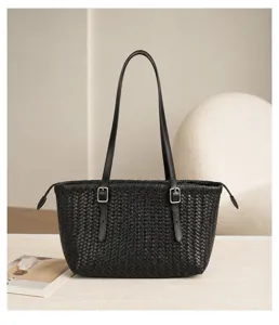 Black woven leather tote bag detail, elegant shoulder bag with buckles for daily wear.