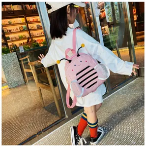 Detail view of cute pink bee toddler backpack with anti-lost strap, perfect for kids outdoor use.