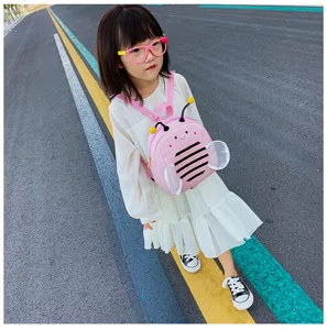Detail view of pink bee toddler backpack outdoors, showing mesh wings and cute antennae.