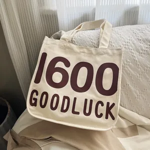 Classic canvas tote bag for women with letter print, casual student shoulder handbag.