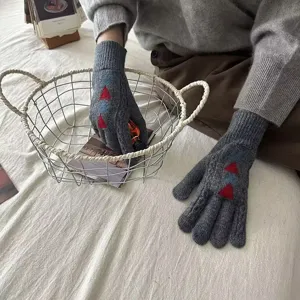 Cozy winter knitted gloves for women with cute red and blue patterns, warm and stylish.