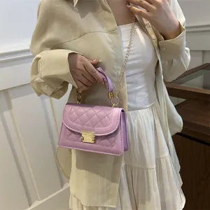 Gros-plan du sac bandoulière matelassé violet avec chaîne, petit sac stylé.