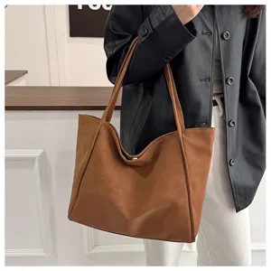 Detail view of a retro brown leather tote bag, large capacity, casual commute shoulder bag.