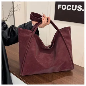 Detailed view of the autumn winter vintage large capacity tote bag in rich burgundy faux leather.