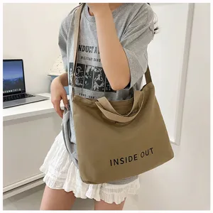 Vintage canvas tote bag for women, large capacity shoulder bag with stylish print detail.