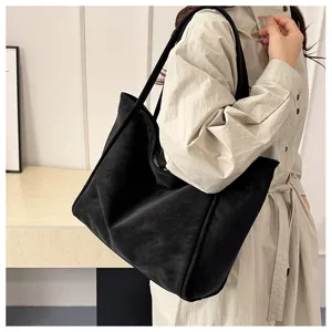 Chic minimalist black tote bag for women, large capacity casual shoulder bag for daily work.