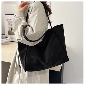 Detailed view of the casual black tote bag showcasing the soft texture and spacious capacity.