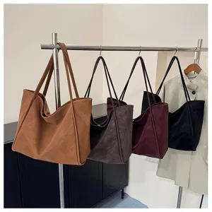Detailed view of large capacity retro tote bags hanging on rack, perfect for daily commuting work.