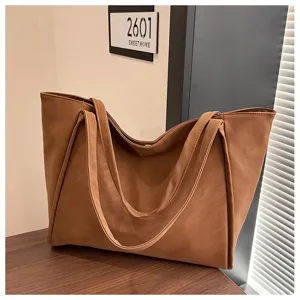 Detailed view of the brown PU leather tote bag, minimalist large capacity shoulder bag.