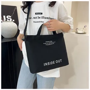 Detailed close-up view of black canvas tote bag showcasing premium cotton material.