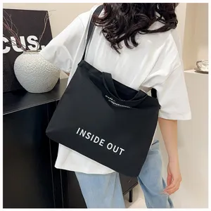 Black canvas tote bag for women, large capacity shoulder and cross-body bag for daily use.