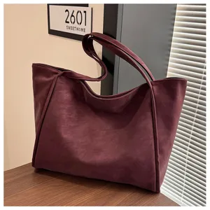 Detail view of the wine red retro tote bag showing premium texture and large capacity.