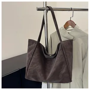 Detailed view of retro brown soft leather tote bag, casual daily shoulder bag for women.