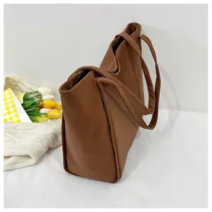 Brown tote shoulder bag detail view, minimalist casual commuter design with large capacity.