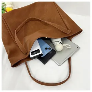 Large capacity brown leather tote bag detail view showing spacious interior storage for daily commuting.