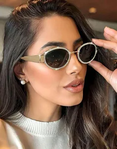 Stilvolle ovale Metallsonnenbrille mit Strassrand und breiten Bügeln Nahaufnahme Detail.