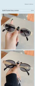 Stylische ovale Sonnenbrille für Damen mit goldenem Metallrahmen und glitzernden Strasssteinen.