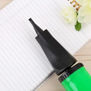 Portable plastic hand balloon pump in green and black for easy party decoration inflation.