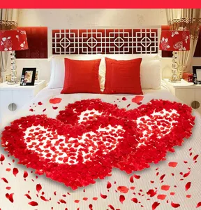Artificial red rose petals for romantic Valentine Day and wedding room decoration.