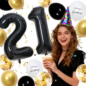 Detail shot of 21st birthday party decorations with black number balloons, confetti and cake.