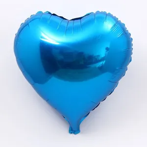 Blue heart foil balloon detail shot showing metallic shiny surface texture and shape clearly.