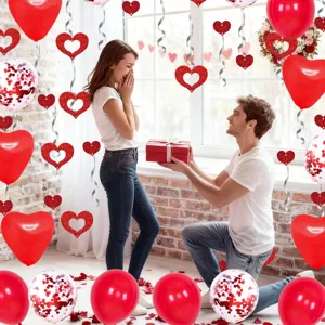 Red heart balloons and hanging decorations set for romantic Valentine's Day proposal setup.