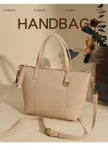 Elegant minimalist light pink PU leather women handbag with shoulder strap and metal details.