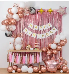 Rose gold birthday party balloon decoration set with fringe curtain and happy banner.