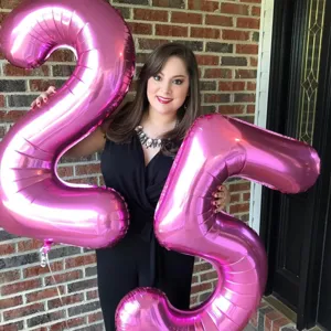 Pink number 25 foil balloons for birthday party decorations, large 40 inch Mylar balloon setup.