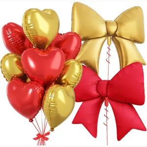 Detailed view of red and gold foil heart and bow balloons set for party decoration.