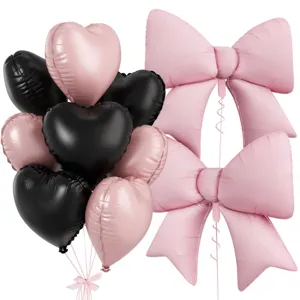 Pink and black heart foil balloons set with large bow balloons for birthday party decor.