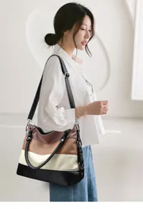 Detail view of the multi-color patchwork shoulder bag worn by model, showing texture and strap.