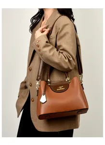 Elegant brown leather shoulder bag featuring a chic woven handle and premium hardware details.