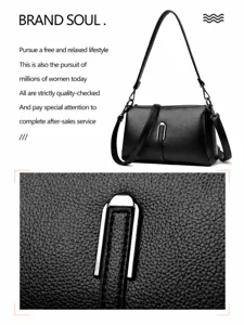 Detailed view of women's black soft leather shoulder bag with metallic U-clasp and fine texture.