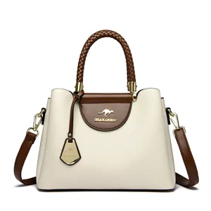 Elegant two-tone women handbag with braided handle and shoulder strap, front view studio shot.