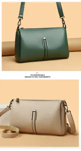 Detail shot of minimalist soft leather crossbody bag with metal buckle and smooth zipper.