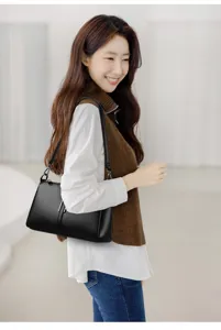 Black leather shoulder bag detail shot, minimalist design, soft daily commuting handbag for women.