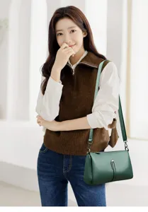 Green leather crossbody shoulder bag detail, elegant design for daily commuting and office.