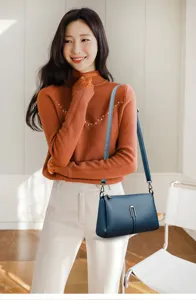 Close-up detail of the stylish women's dark blue soft leather crossbody shoulder bag.
