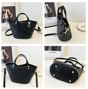Black textured bucket bag detailed view, showcasing premium leather finish and chic hardware.