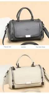 Detailed view of stylish leather handbag with top handle, zipper closure, and shoulder strap.